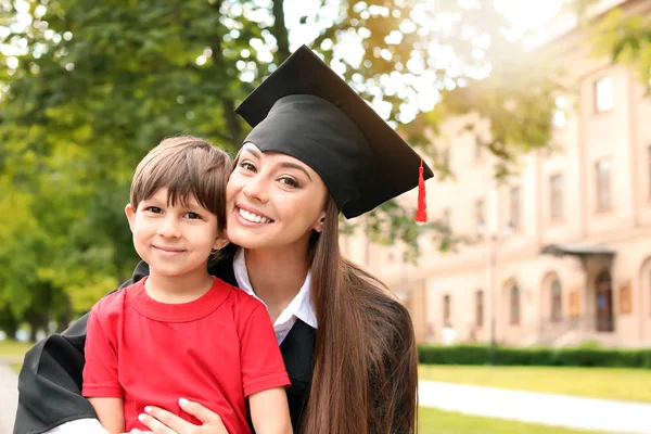 Woman with little son on her graduation day — Stock Photo, Image