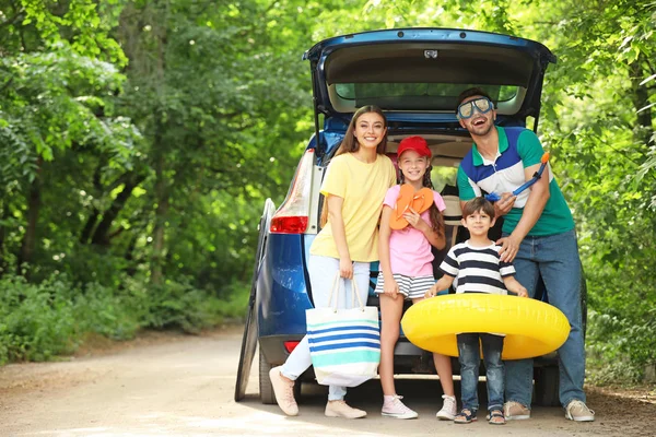 Familia feliz cerca de coche preparado para viajar —  Fotos de Stock