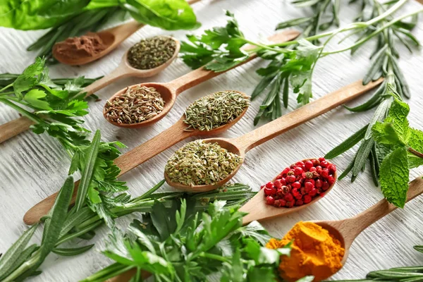 Different herbs and spices on white wooden background — Stock Photo, Image