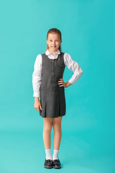 Cute little schoolgirl on color background — Stock Photo, Image
