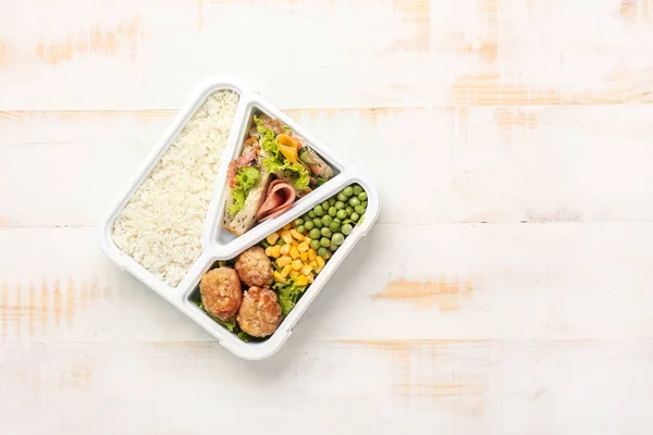 School lunch box with tasty food on white wooden table — Stock Photo, Image