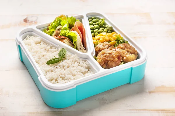 School lunch box with tasty food on white wooden table — Stock Photo, Image