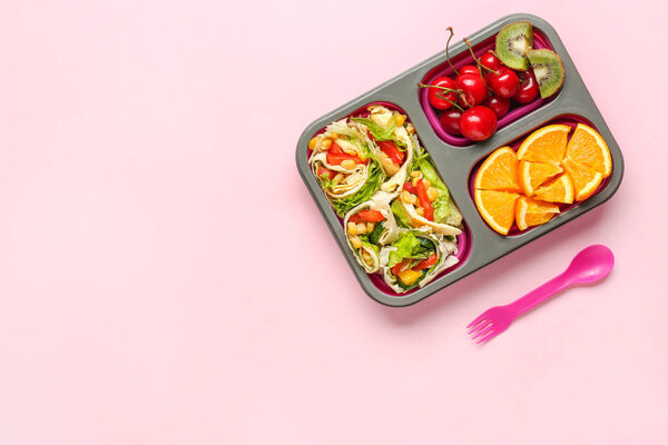 School lunch box with tasty food on color background