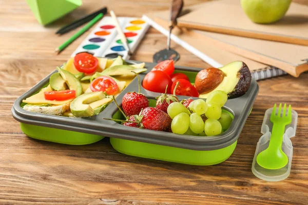 School lunch box with tasty food on wooden table — Stock Photo, Image