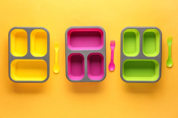 Plastic lunch boxes on color background — Stock Photo, Image