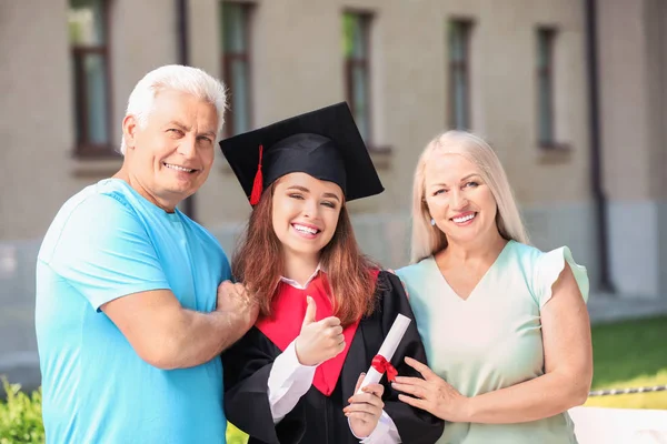 Happy young woman with her parents on graduation day — Stock Photo, Image