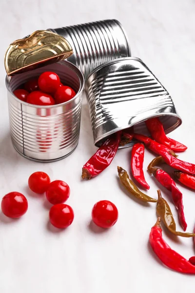 Tin cans with vegetables on light table — Stock Photo, Image