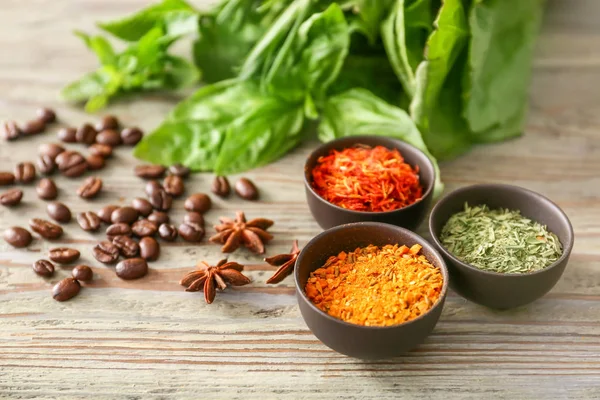 Different herbs and spices on wooden background — Stock Photo, Image