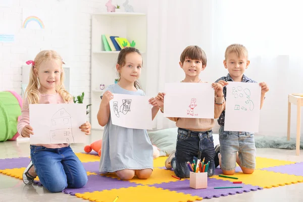 Cute little children with pictures in kindergarten — Stock Photo, Image