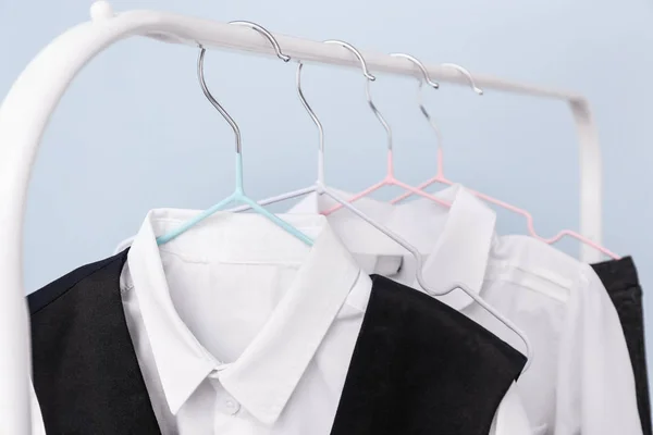 Stylish school uniform hanging on rack, closeup — Stock Photo, Image