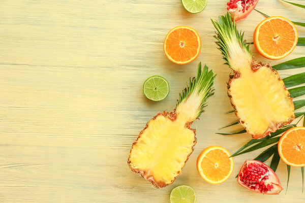 Many different fruits on wooden background