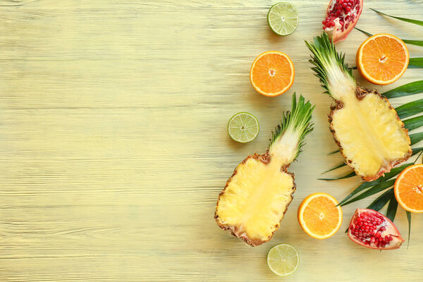 Many different fruits on wooden background