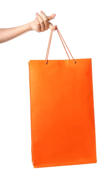 Mano femenina con bolsa de compras sobre fondo blanco — Foto de Stock