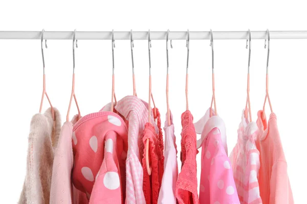 Stylish kid clothes hanging on rack against white background — Stock Photo, Image
