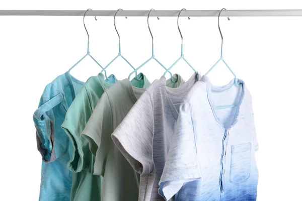 Stylish kid clothes hanging on rack against white background — Stock Photo, Image