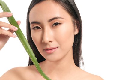 Beautiful Asian woman with aloe vera on white background clipart