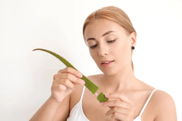 Beautiful young woman with aloe vera on white background — Stock Photo, Image