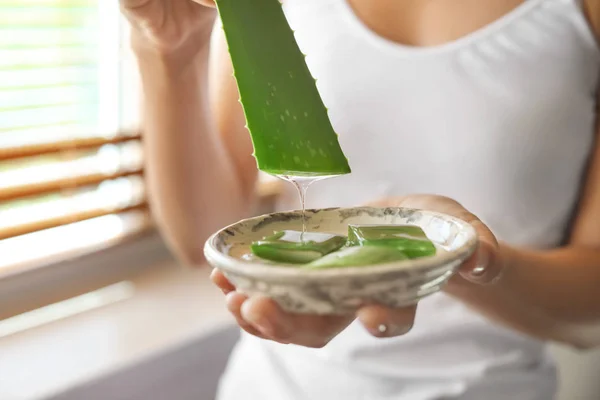 Beautiful young woman using aloe vera at home, closeup — Stock Photo, Image