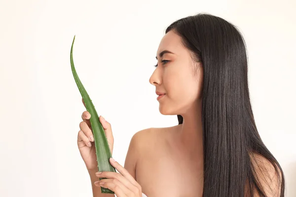 Beautiful Asian woman with aloe vera on white background — Stock Photo, Image