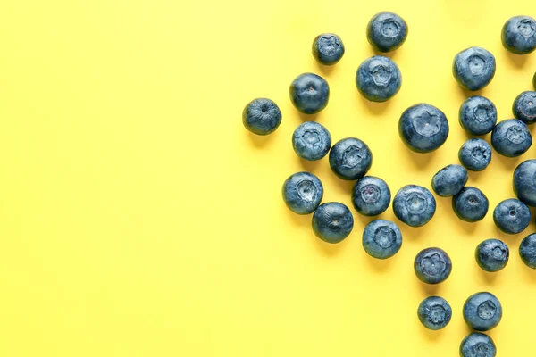 Many ripe blueberry on color background — Stock Photo, Image