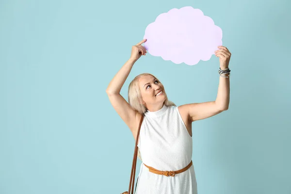 Mature woman with speech bubble on light background — Stock Photo, Image