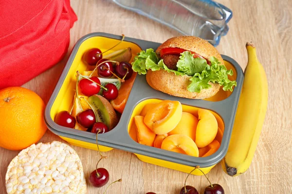 School lunch box with tasty food on table — Stock Photo, Image