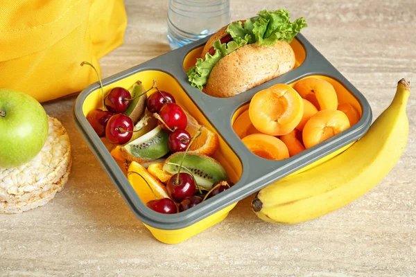 School lunch box with tasty food on table — Stock Photo, Image