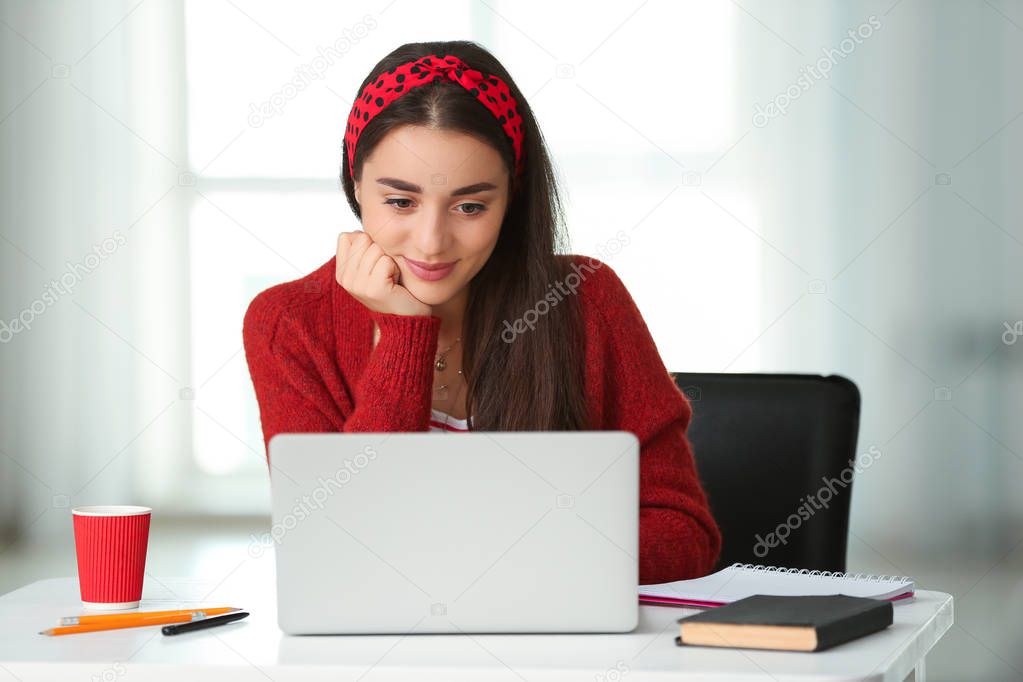 Female student with laptop preparing for exam at home