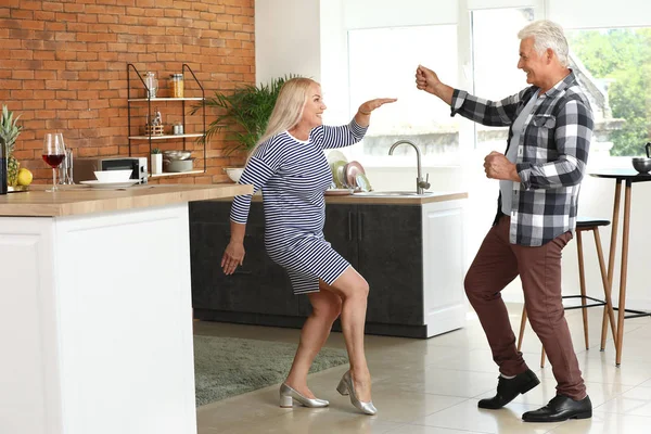 Happy mature couple dancing at home — Stock Photo, Image