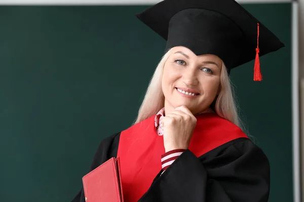 Mulher madura em roupão de solteiro na universidade — Fotografia de Stock