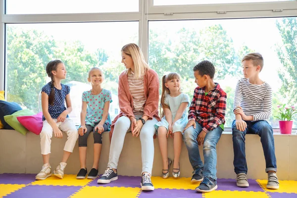 Cute children with teacher in primary school — Stock Photo, Image