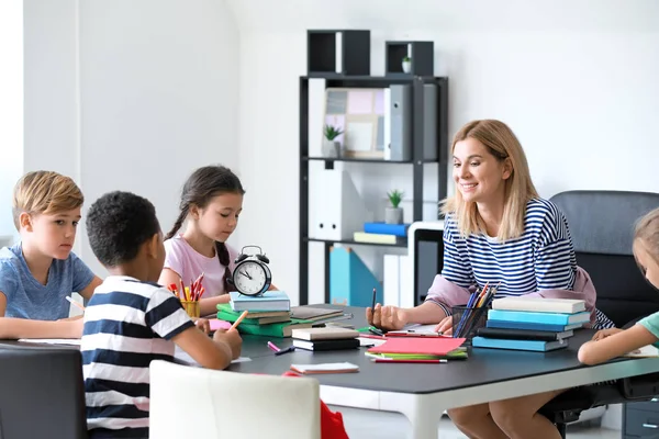 Cute children with teacher during lesson in classroom — Stock Photo, Image