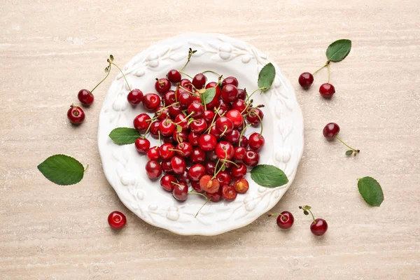 stock image Plate with ripe cherry on table