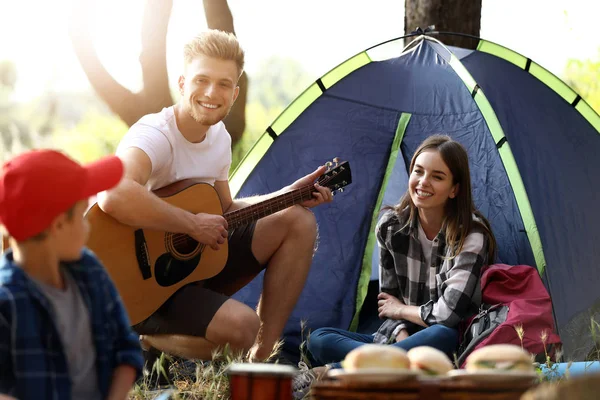 Happy family spending weekend in forest