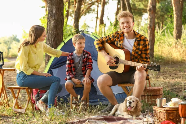 Happy family spending weekend in forest