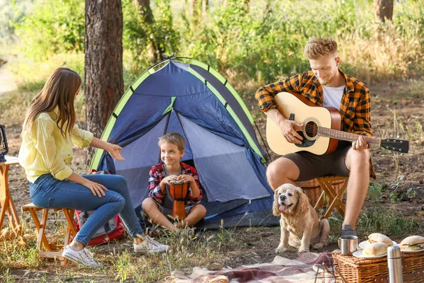 Happy family spending weekend in forest