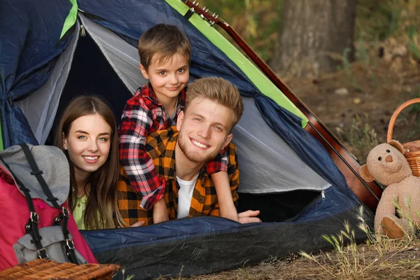 Happy family spending weekend in forest