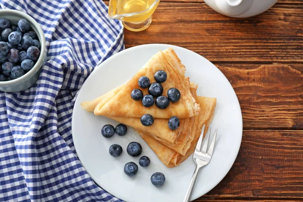 Plate with tasty blini and blueberry on table — Stock Photo, Image