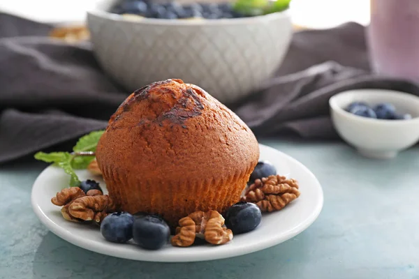 Plate with tasty blueberry muffin on table — Stock Photo, Image