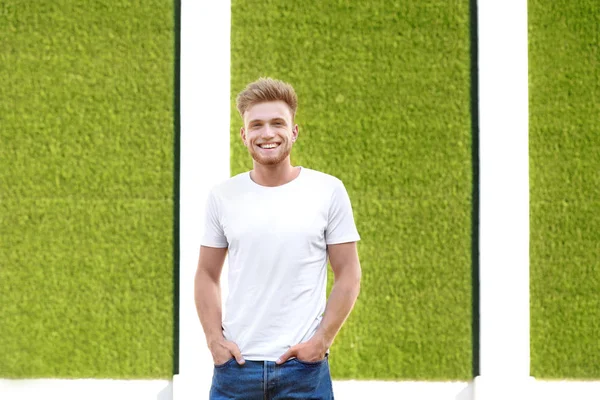 Man in stylish t-shirt on color background — Stock Photo, Image