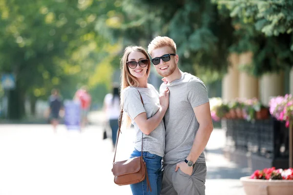 Man and woman in stylish t-shirts outdoors