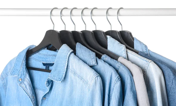 Rack with hanging clothes on white background — Stock Photo, Image