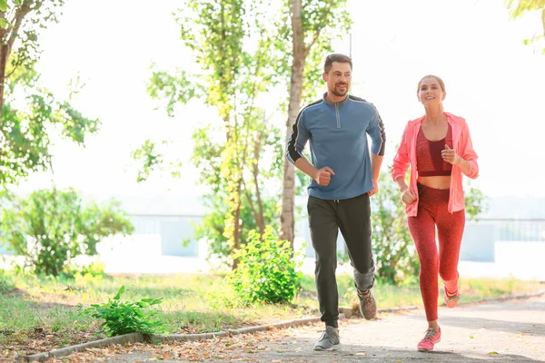 Sporty couple in love running outdoors — Stock Photo, Image