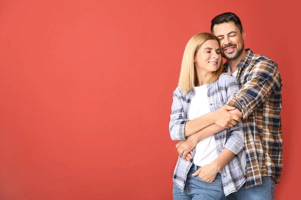 Portrait of happy couple in love on color background — Stock Photo, Image