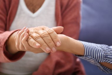 Evde yaşlı anneye destek olan genç kız, yakın çekim