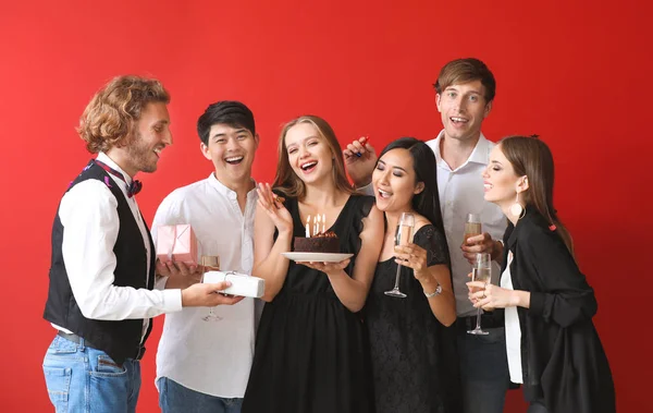 Group of friends celebrating Birthday on color background — Stock Photo, Image