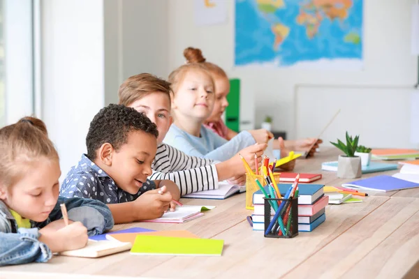 Cute little pupils during lesson in classroom — Stock Photo, Image