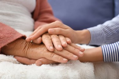 Evde yaşlı anneye destek olan genç kız, yakın çekim