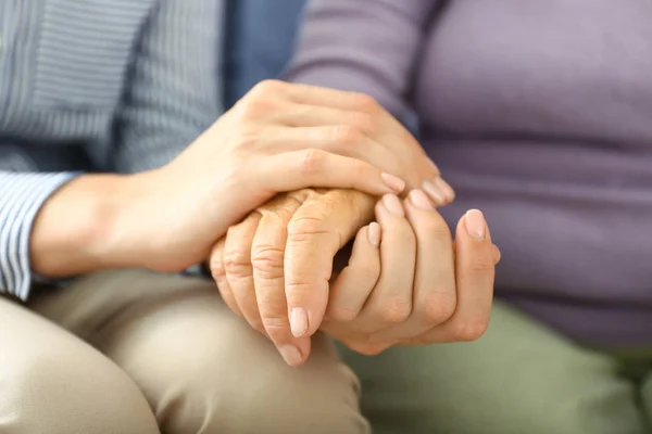 Young daughter supporting elderly mother at home, closeup — Stock Photo, Image