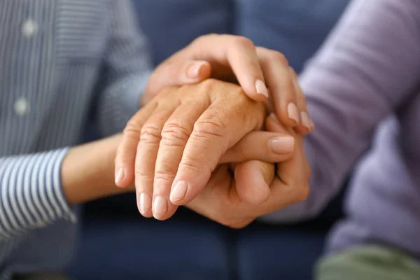 Young daughter supporting elderly mother at home, closeup — Stock Photo, Image